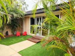 Courtyard::Private courtyard with lovely easy maintenance golden canes and artificial turf.